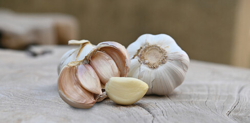 Garlic, garlic cloves on a wooden plate.