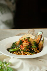 Delicious Seafood Spaghetti with Herbs and Spices on a Plate. This dish combines spaghetti, shrimp, and mussels.