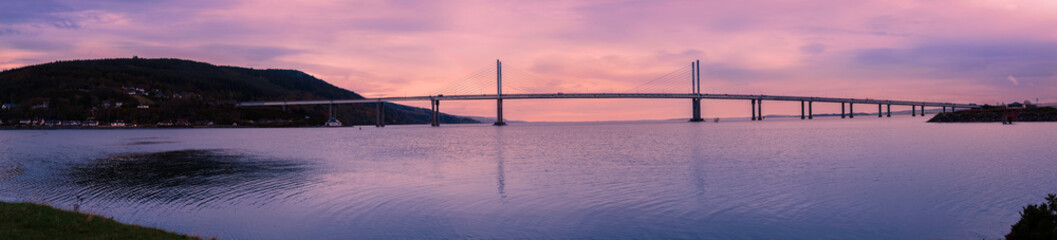 Kessock Bridge and Charlestown hills, a tranquil sunset panoramic view from Carnarc Point over the Beauly Firth, where River Beauly and River Ness meet in Scotland, United Kingdom.