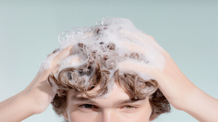 Man hands massaging wet curly hair with shampoo foam, personal care, cleanliness and scalp health banner for beauty industry