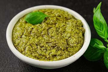 Pesto sauce basil, olive oil, parmesan, pine nuts, garlic natural product tasty snack fresh delicious gourmet food background on the table rustic top view copy space