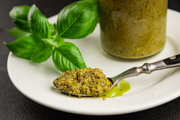 Pesto sauce basil, olive oil, parmesan, pine nuts, garlic natural product tasty snack fresh delicious gourmet food background on the table rustic top view copy space