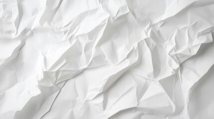 Obraz premium A close-up view of crumpled white paper texture showing folds and wrinkles, creating an abstract pattern ideal for backgrounds.