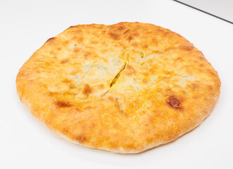 Golden Baked Georgian Kubdari With Flaky Crust And Meat Filling On White Plate
