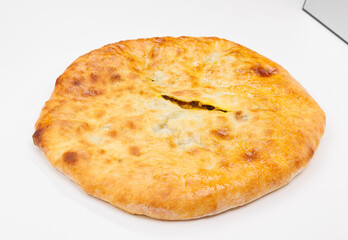 Golden Baked Georgian Kubdari With Flaky Crust And Meat Filling On White Plate
