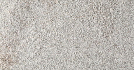 Pile of integral barley flour background and texture, top view