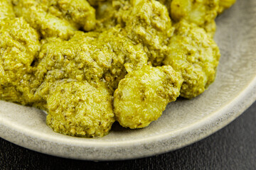 Gnocchi pesto sauce green tasty snack fresh gourmet food background on the table rustic top view copy space vegerian and vegan food