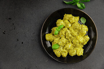 Gnocchi pesto sauce green tasty snack fresh gourmet food background on the table rustic top view copy space vegerian and vegan food