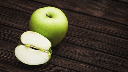 Green apples on dark brown wooden background. Summer fruits. Natural vitamins. Healthy food.