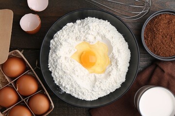 Ingredients for dough on wooden table, flat lay
