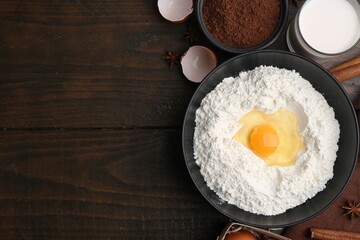 Ingredients for dough on wooden table, flat lay. Space for text