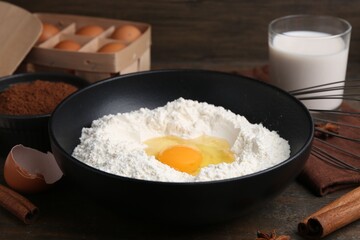 Ingredients for dough on wooden table, closeup