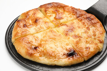 Cut delicious Megrelian khachapuri on white background, closeup