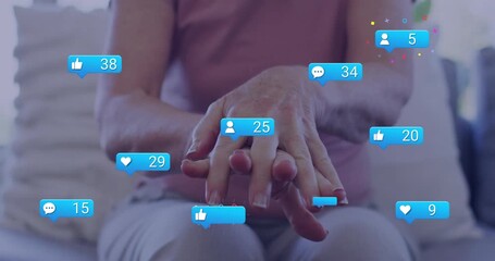 Senior woman rubbing hands and activating floating engagement icons showcasing social media growth - Powered by Adobe