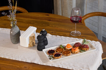 An Elegant Table Setting Featuring Gourmet Appetizers Accompanied by Fine Wine Selection