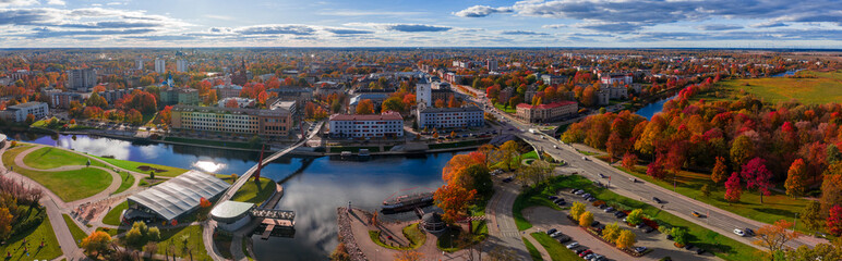 Aerial view of Jelgava, Latvia, shows Lielupe River, Pasta sala, and an arched footbridge. Late...