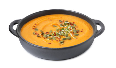 Delicious pumpkin soup with seeds and spices in bowl isolated on white