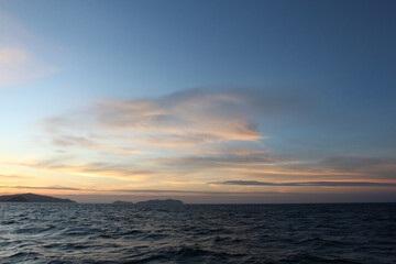 Sea on a winter morning with strong winds and the rays of the morning sun on the horizon.