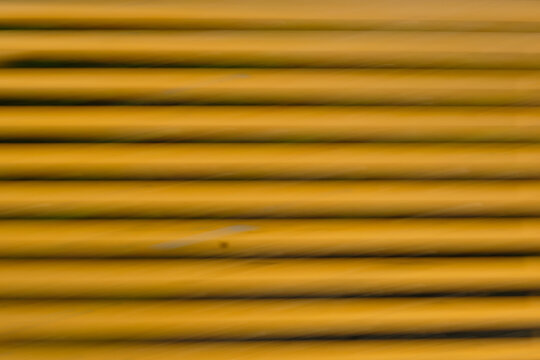 The image is a close up of a yellow object with a lot of lines