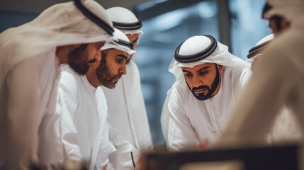 Middle Eastern corporate team in traditional Emirati attire collaborating in an office in Dubai