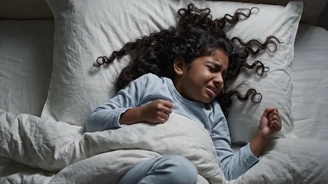 Scared little girl having a bad dream in bed. Night terrors of a child. Fear afraid of monsters in darkness in bedroom in Child nightmares imagination and psychological distress concept. African