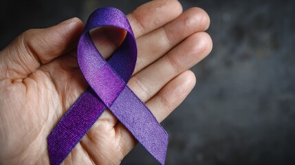 Holding a purple ribbon for awareness of various cancers Alzheimer s epilepsy lupus sarcoidosis fibromyalgia and domestic violence Concept for World Cancer Day