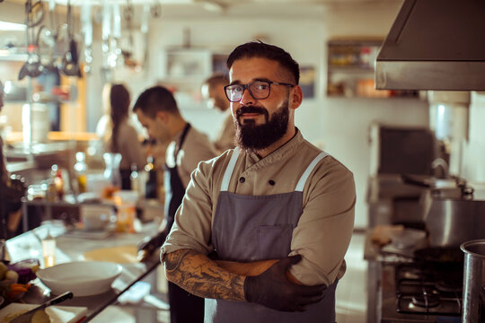 Young adult chef in restaurant kitchen