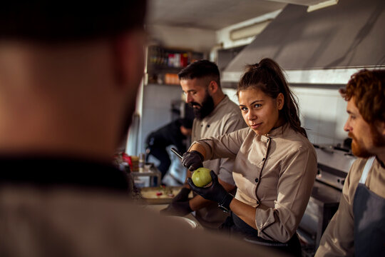Young adult chefs working in restaurant kitchen