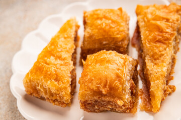 Baklava with pistachios and almonds dessert oriental sweets natural product tasty snack fresh delicious gourmet food background on the table rustic top view copy space