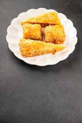Baklava with pistachios and almonds dessert oriental sweets natural product tasty snack fresh delicious gourmet food background on the table rustic top view copy space