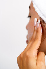 Young woman cleansing face during morning beauty routine