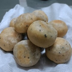 A close-up of crispy golden khasta kachoris, a popular Indian snack made with flour and stuffed with spiced lentils, served on a white cloth.