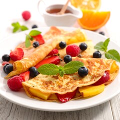 Delightful cr?pes with fresh berries, mango, and a drizzle of honey