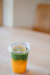 Iced yuzu matcha drink on a neutral background soft shadows summer drinks, copy space concept.