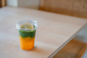 Iced yuzu matcha drink on a neutral background soft shadows summer drinks, copy space concept.