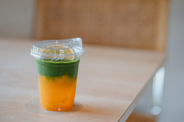 Iced yuzu matcha drink on a neutral background soft shadows summer drinks, copy space concept.