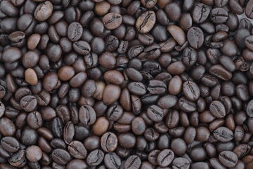 Coffee texture roasted beans from above soft light. Big amount of coffee beans