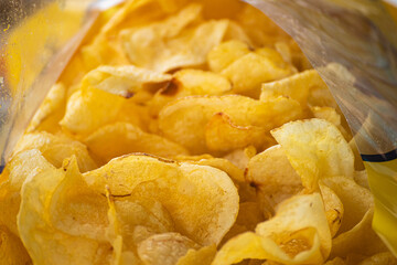 A macro shot from inside a bag of golden potato chips The Irresistible Crunch of a Snack