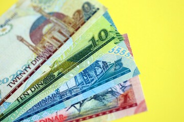 Bahraini dinar money bills in big amount on yellow close up. Finance and banking concept