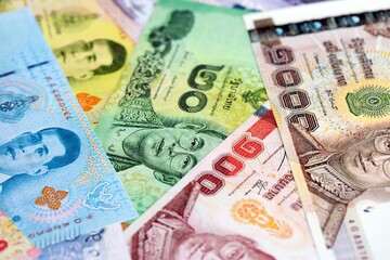 Thai baht currency money bills. The current banknotes lies on table in big amount close up