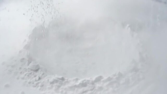 White Powder Explosion Abstract - This video shows a close-up of a white substance exploding outward. The abstract and blurred nature of the scene creates an interesting and dynamic visual effect.