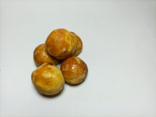 Nastar cookies or pineapple tarts contain pineapple jam on an isolated white background and copy space. Traditional Indonesian cake is popular during Eid al-Fitr and Eid al-Adha celebrations.