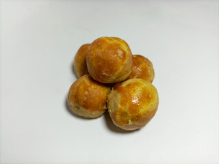 Nastar cookies or pineapple tarts contain pineapple jam on an isolated white background and copy space. Traditional Indonesian cake is popular during Eid al-Fitr and Eid al-Adha celebrations.