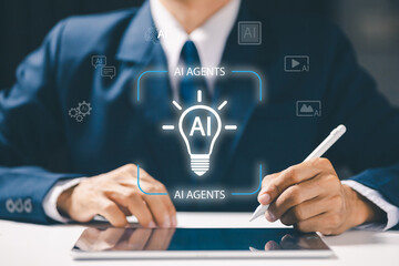 A businessman using stylus pen with AI light bulb hologram labeled AI Agents, representing artificial intelligence ideas, innovation, and intelligent digital business solutions.
