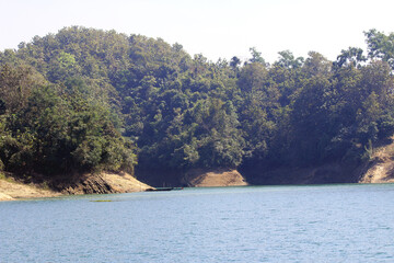 Green Hills and Sparkling Lake under Blue Sky