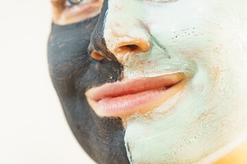Girl black and green mud mask on face