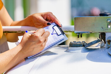 Woman checking level of propane gas in tank