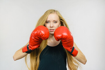Woman in gloves playing sports boxing