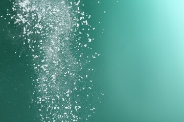 Dry talcum powder falling on green background, closeup. Space for text