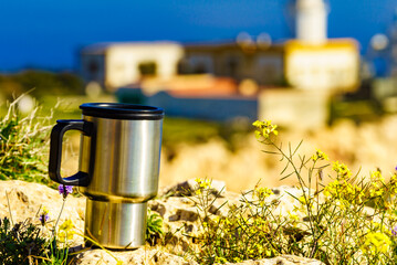 Thermal mug, thermos on nature. Travel outdoor picnic.